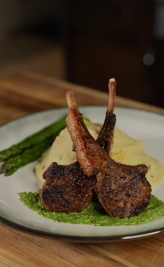 Herb-Crusted Lamb Chops with Mint Pesto, Garlic Mashed Potatoes, and Grilled Asparagus.